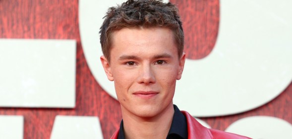 Edvin Ryding on a red carpet, wearing a black shirt and red leather jacket