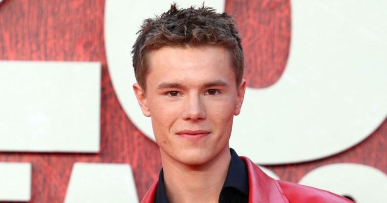 Edvin Ryding on a red carpet, wearing a black shirt and red leather jacket