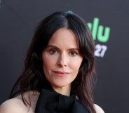 Emily Hampshire in a black dress