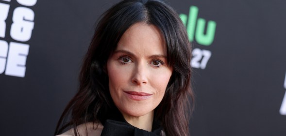 Emily Hampshire in a black dress
