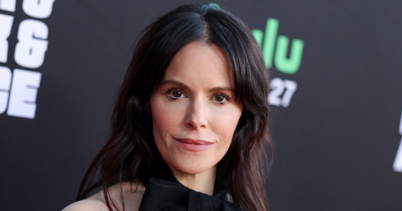 Emily Hampshire in a black dress