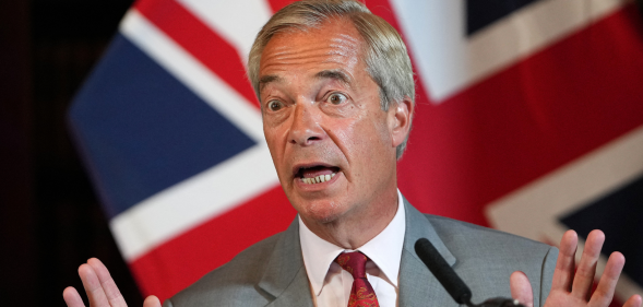 Reform UK Leader Nigel Farage attend a press conference, union jack flag behind him