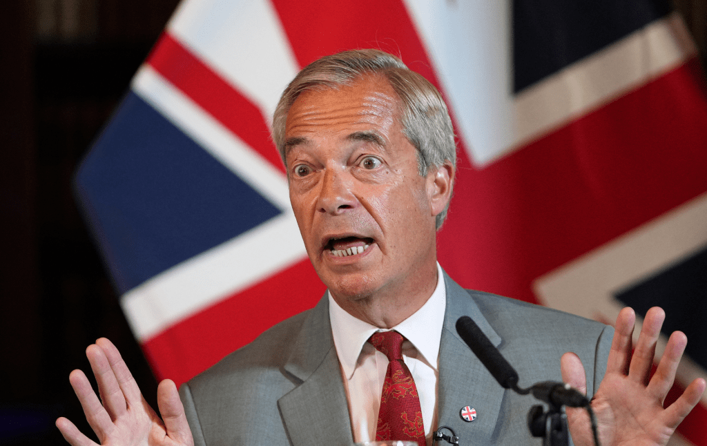 Reform UK Leader Nigel Farage attend a press conference, union jack flag behind him
