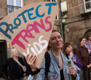 Someone holding a sign reading 'Protect trans kids'