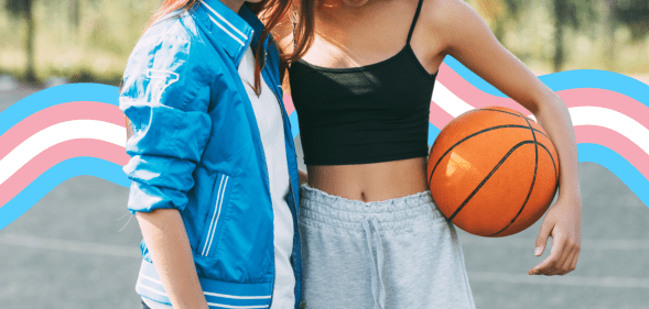 Two faceless girls on a basketball court. One of them is holding a basketball under her arm. There is a banner in the colours of the trans flag behind them.