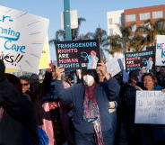 People holding signs in favour of gender-affirming care