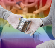 Volunteers passing cans in a food bank with a rainbow background