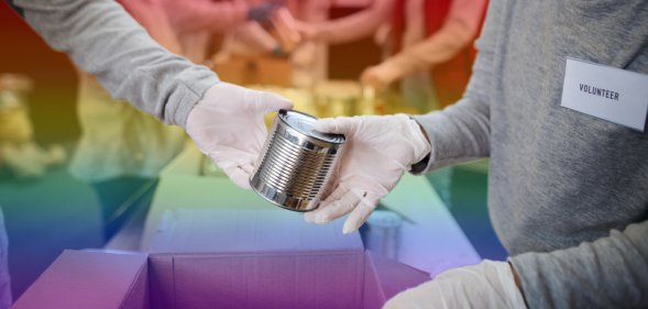 Volunteers passing cans in a food bank with a rainbow background