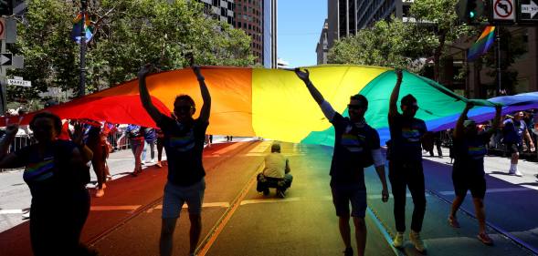 Marchers carry an oversized Pride flag during the 52nd annual San Francisco Pride Parade