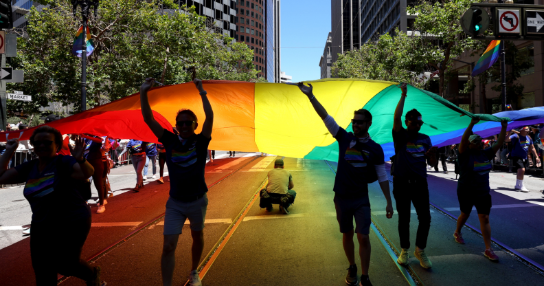 Marchers carry an oversized Pride flag during the 52nd annual San Francisco Pride Parade