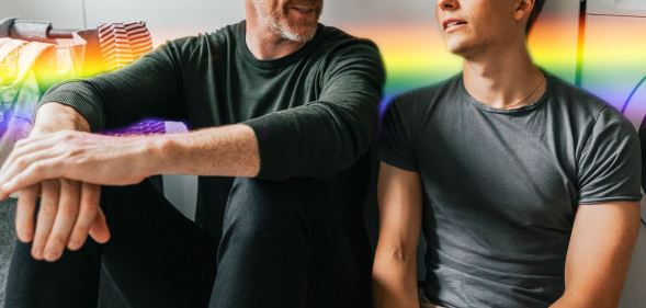older man with a younger man with rainbow colours behind them