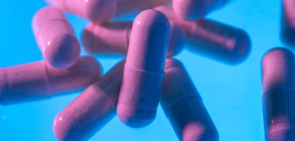 pink pills on a blue background