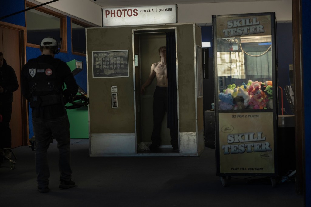 Ryan (Stacy Claisen) in a photobooth, shirtless