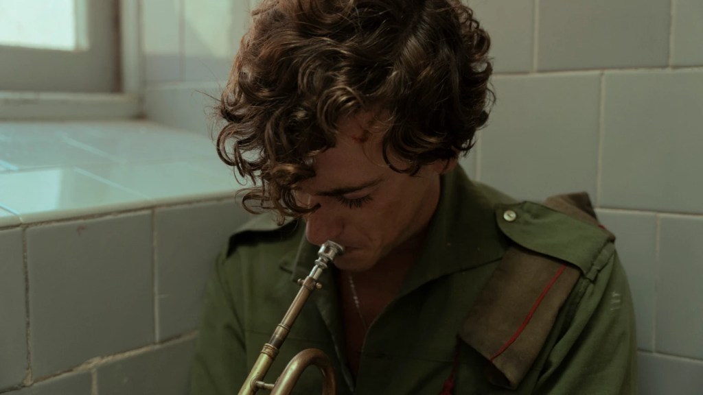 La Bola Negra: a young man playing a trumpet.