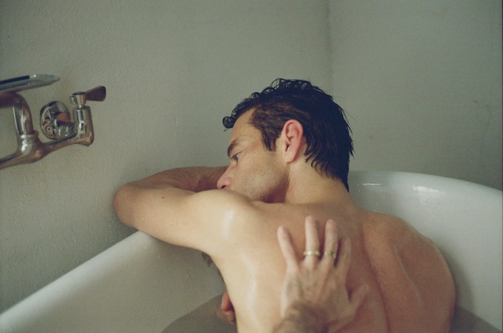 The Man I Love: a man in the bathtub with his back to the camera, another man's head resting on his bare back