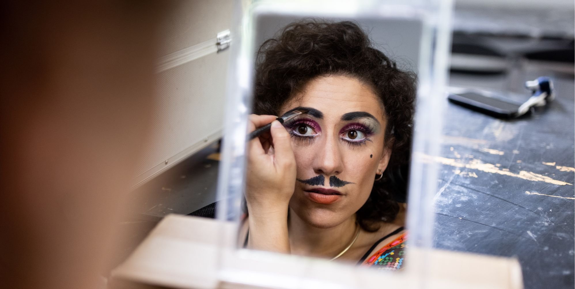 Drag king/artist doing makeup