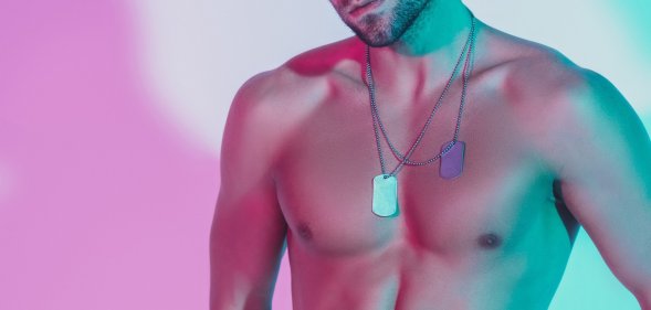 A shirtless model poses for a portrait