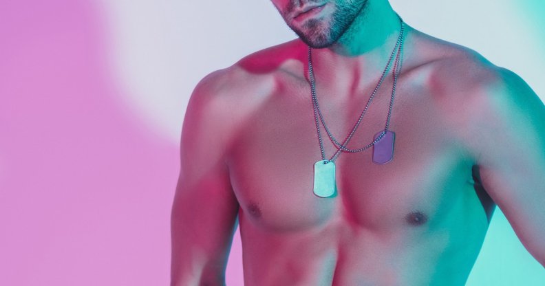 A shirtless model poses for a portrait