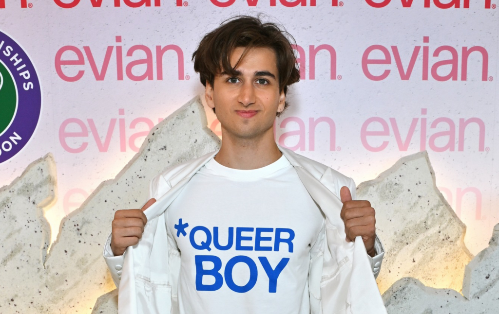 Sebastian Croft wearing a white t-shirt with blue lettering 'queer boy'