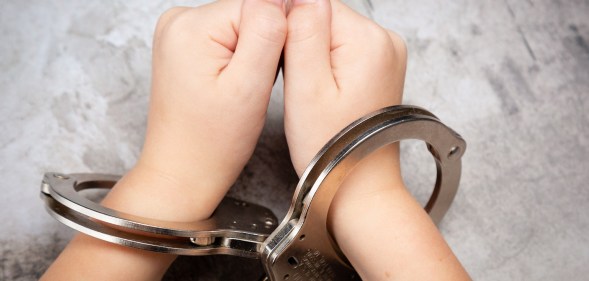 person in handcuffs