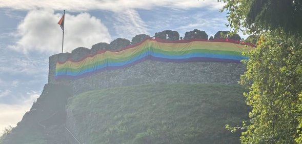 Totnes Castle wrapped in a giant Pride flag