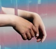a person in prison with the trans Pride flag colours