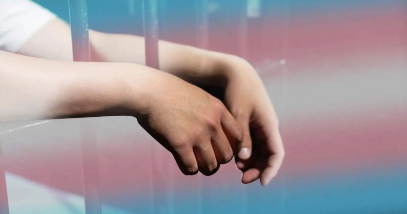 a person in prison with the trans Pride flag colours