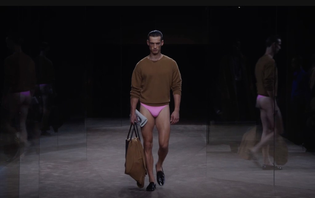 Model wearing Tom Ford's skimpy pink underwear with brown jumper