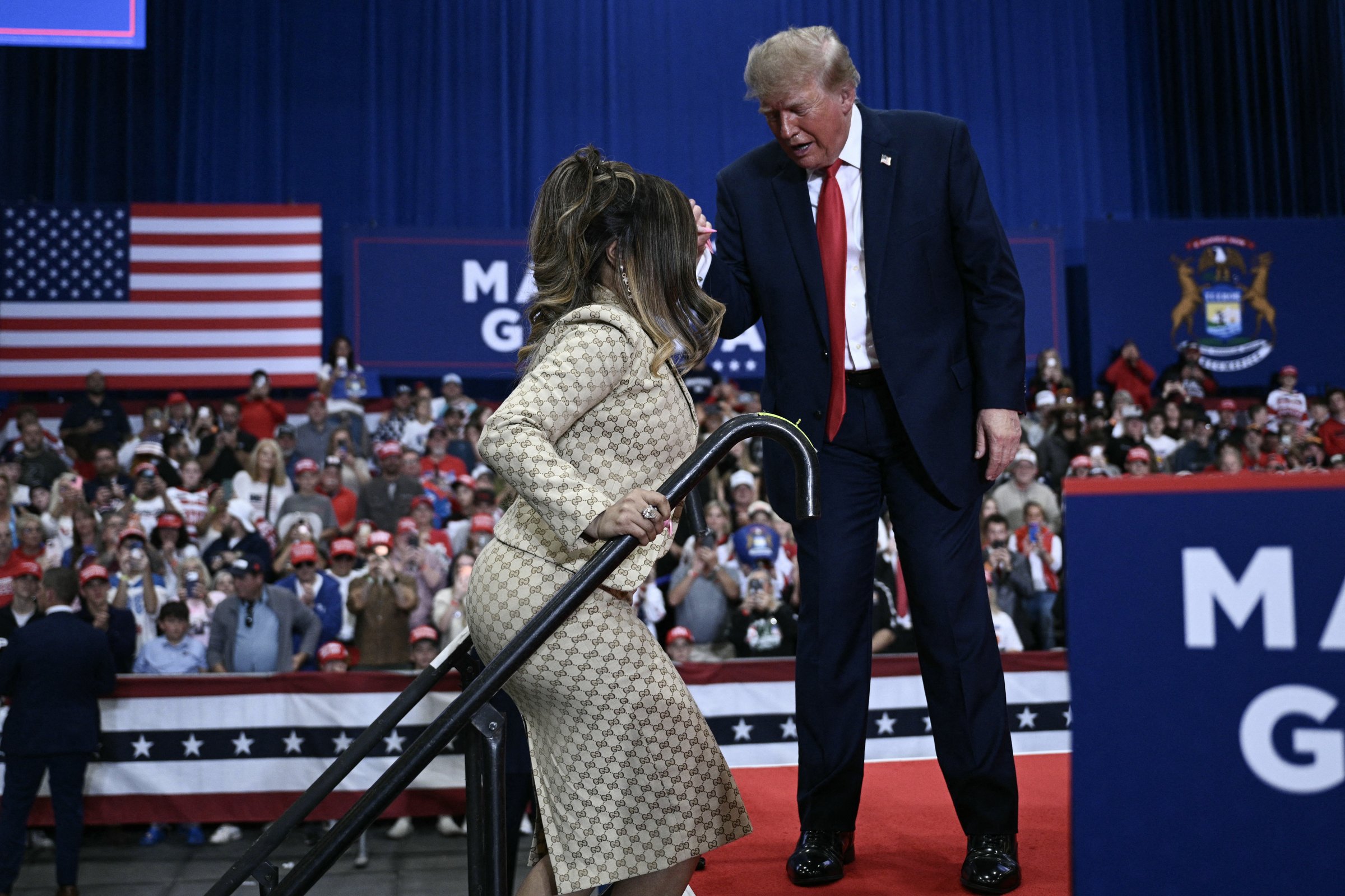US President Donald Trump helps rapper Nicki Minaj on stage during a campaign rally at the McMorran Place Sports & Entertainment Center in Port Huron, Michigan, on October 25, 2026. (Photo by Brendan