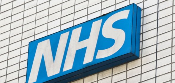 A skewed shot of an NHS sign.