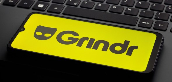 In this photo illustration, the Grindr logo is seen displayed on a smartphone screen