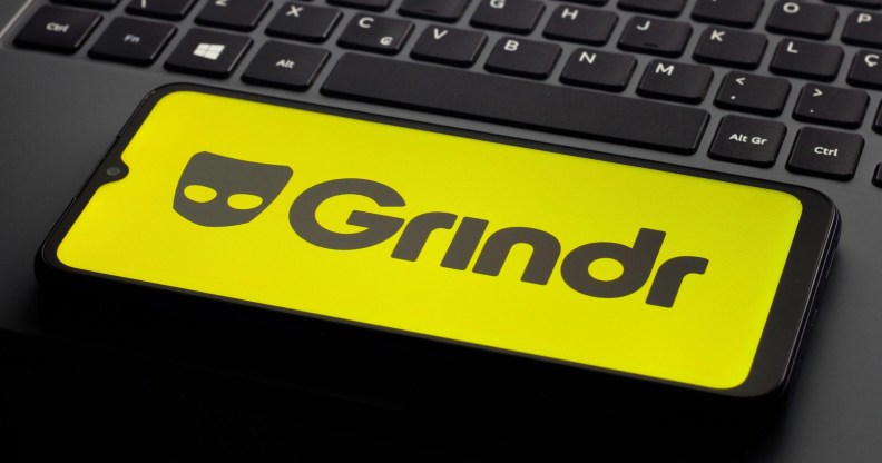 In this photo illustration, the Grindr logo is seen displayed on a smartphone screen