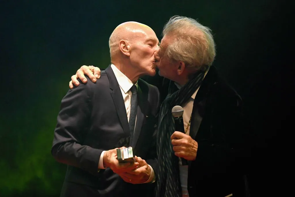 Sir Ian McKellen kissing Sir Patrick Stewart on stage as he presents him with the Empire Legend award