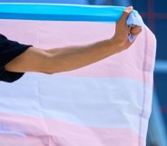 Person holds transgender Pride flag