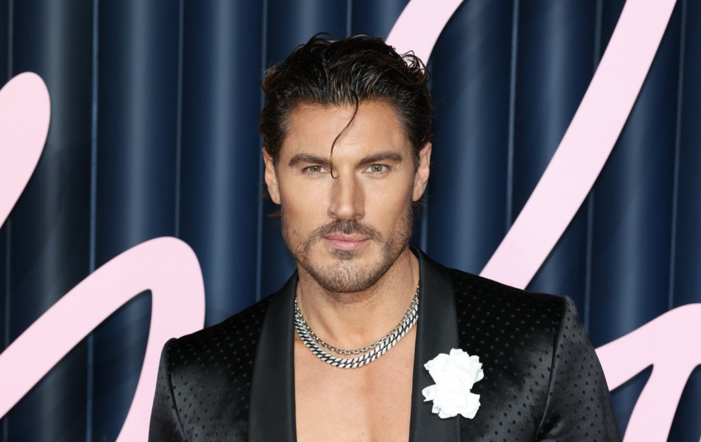 Chris Appleton attends The Fashion Awards, shirtless but wearing black blazer, one strand of hair over his ace