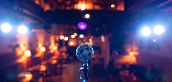 Microphone Stands Ready on Stage in Dimly Lit Bar