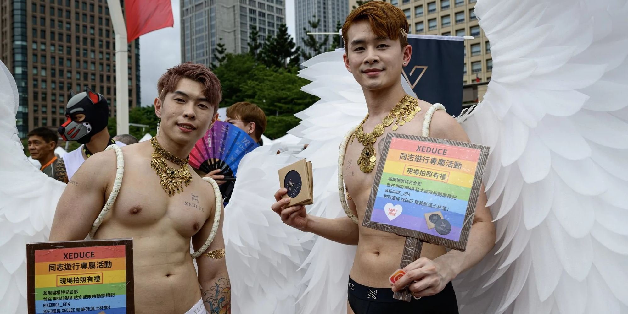 Dressed as angels, two gay men take part at the Taiwan LGBT Plus Pride day in downtown Taipei in 2025