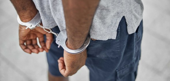 Person in Handcuffs Wearing Gray T-Shirt